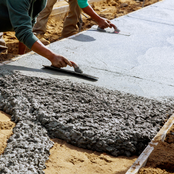 Picture of man leveling concrete sidewalk